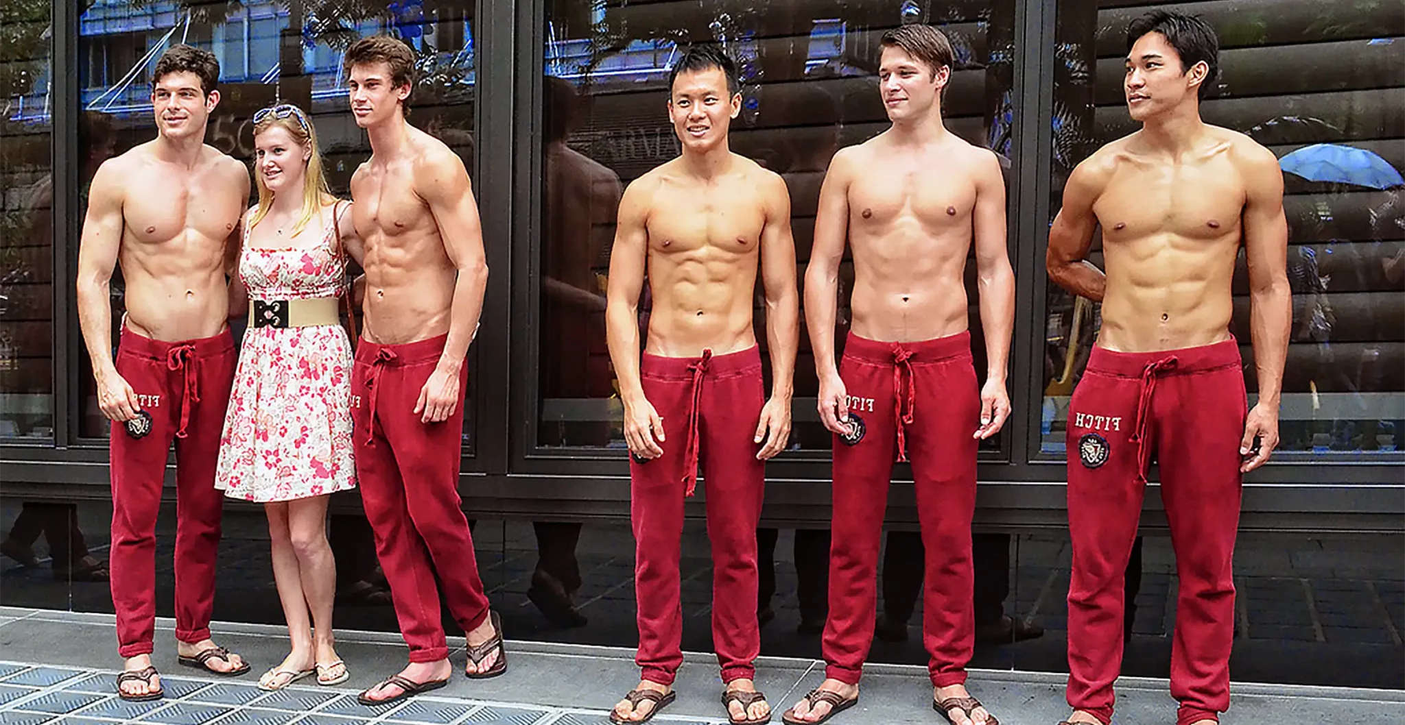 Modèles masculins torse nu en pantalon de jogging rouge, illustrant un physique athlétique et sec typique du mannequinat masculin.