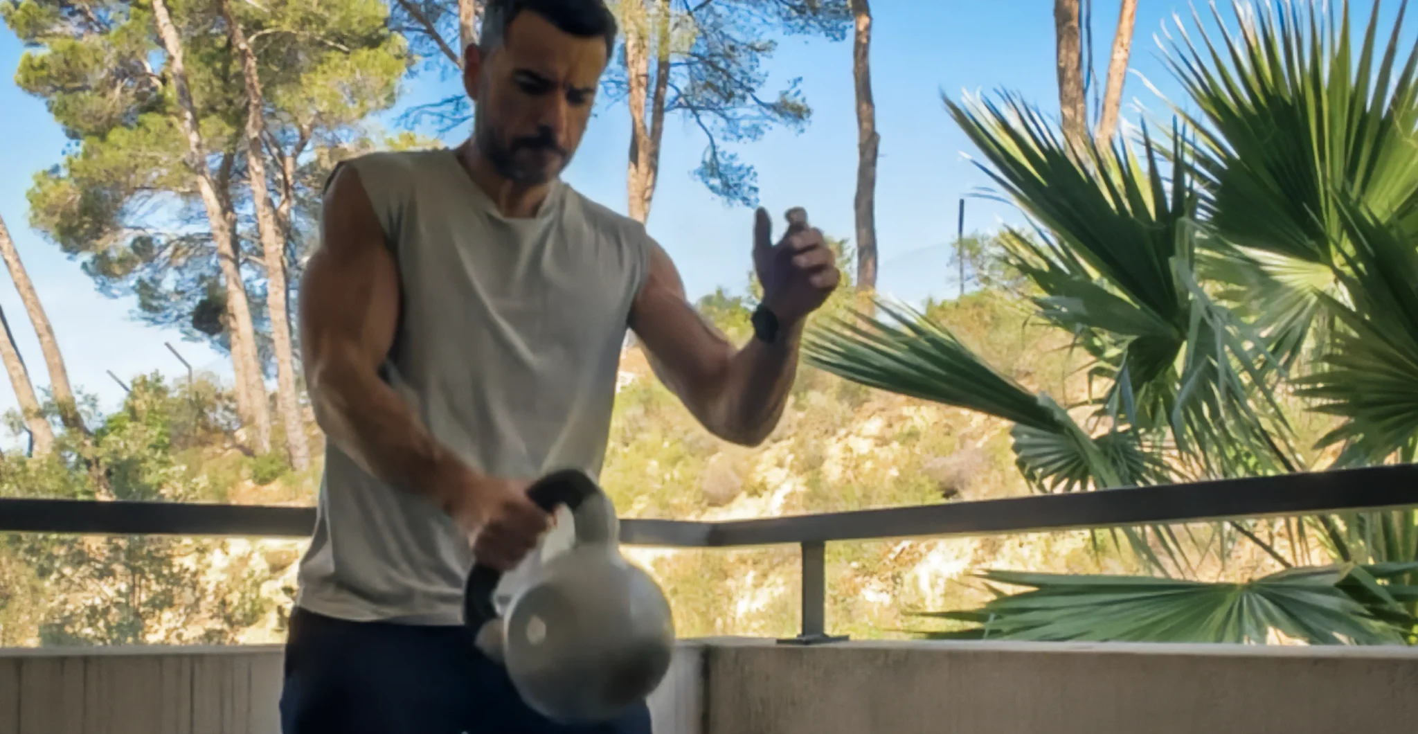 Homme réalisant un exercice avec kettlebell à un bras pour renforcer le gainage abdominal et les muscles stabilisateurs du tronc.